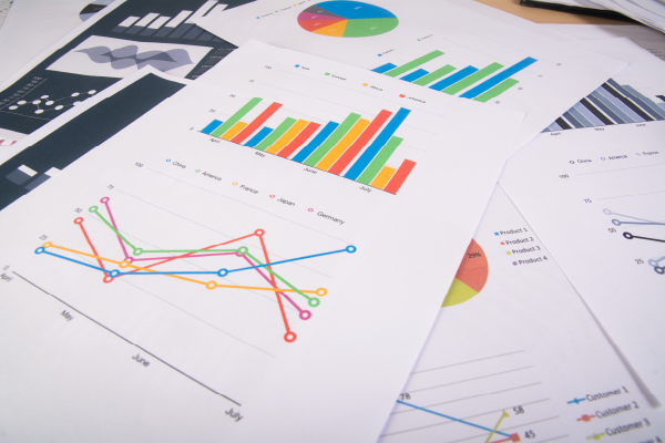 Photo of pile of documents with charts and graphs