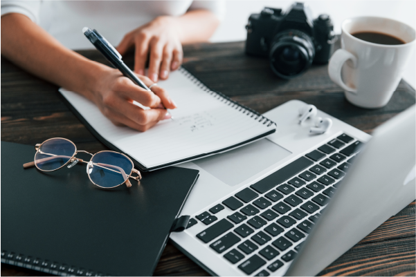 Photo of someone writing on a notepad