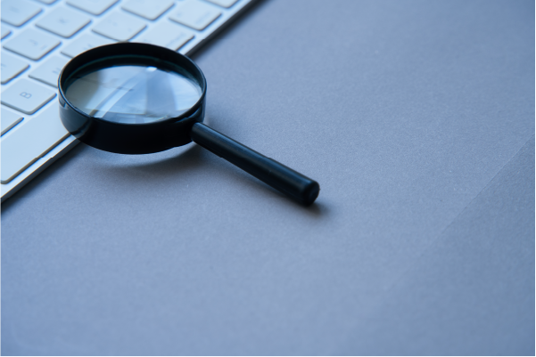 Photo of a magnifying glass on a computer keyboard