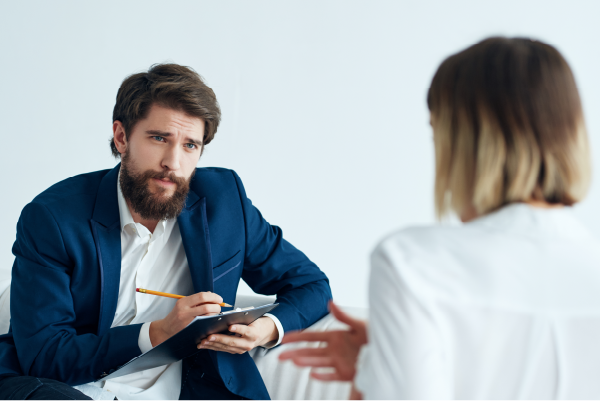 Photo of man interviewing a woman