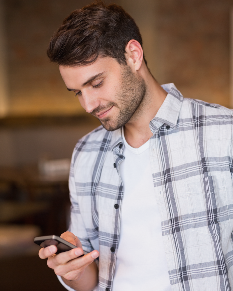 photo of man looking at a smartphone