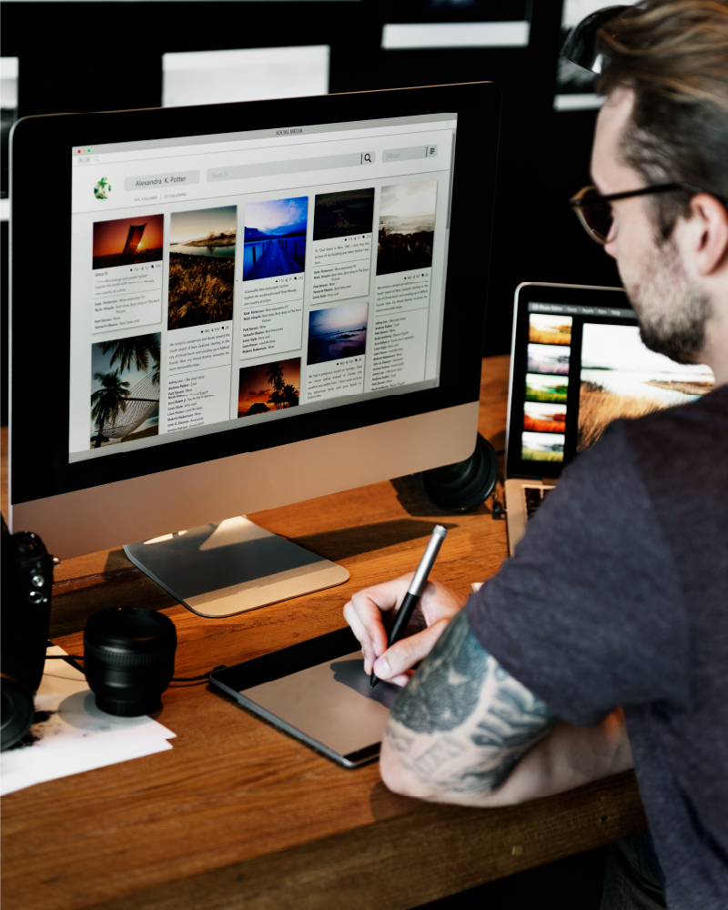 photo of man on computer building a website